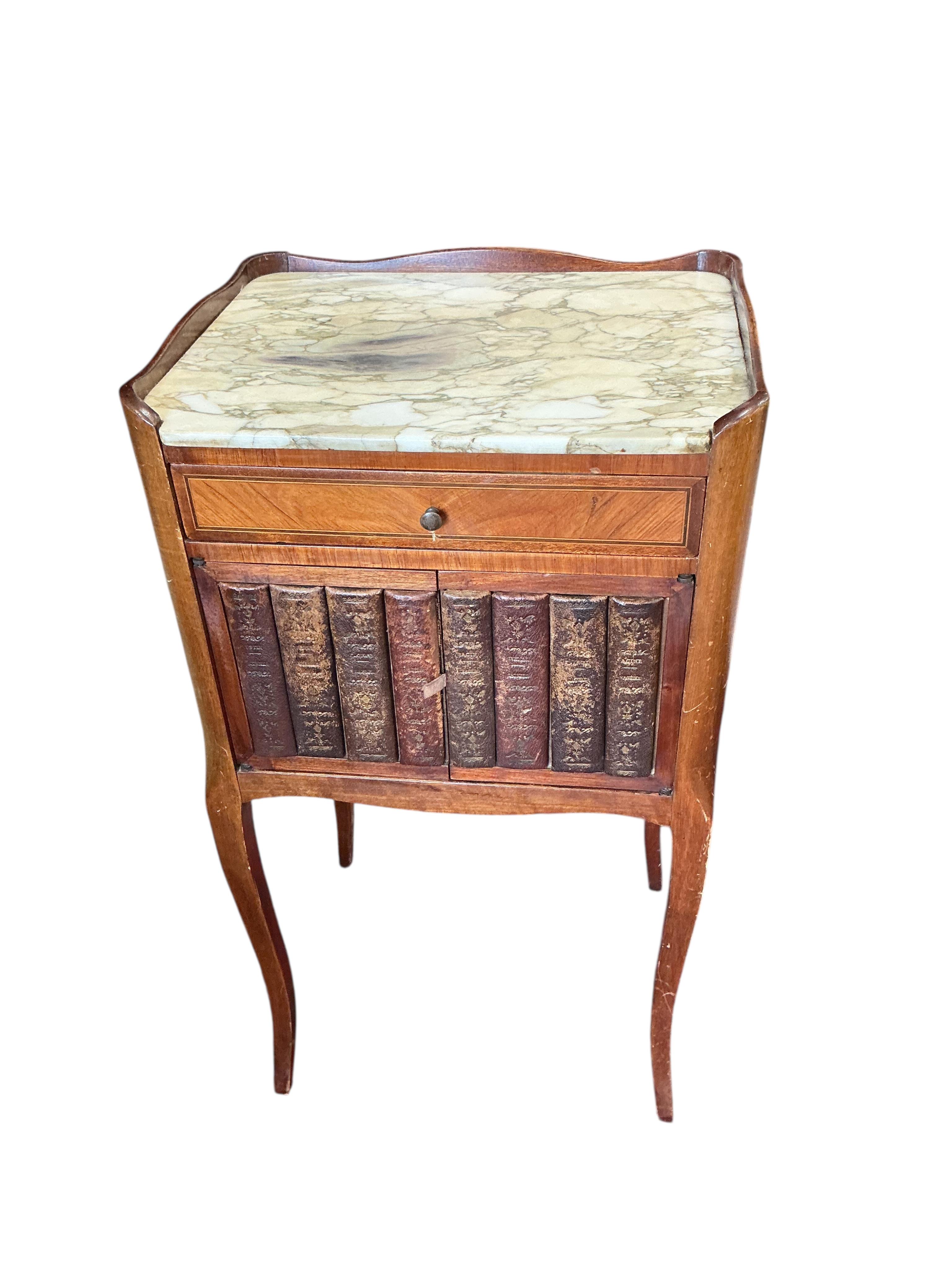 A pair of French marble topped kingswood bedside cabinets with faux book spine doors, width 39cm, depth 30cm, height 74cm